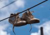 Many People Still Don’t Know The Meaning Behind Shoes Strung Up On A Power Line Many People Still Don’t Know The Meaning Behind Shoes Strung Up On A Power Line - featured image
