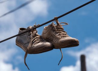 Many People Still Don’t Know The Meaning Behind Shoes Strung Up On A Power Line Many People Still Don’t Know The Meaning Behind Shoes Strung Up On A Power Line - featured image