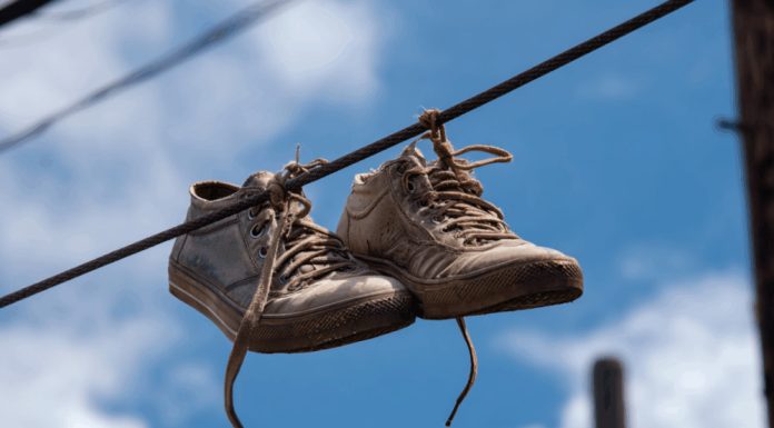 Many People Still Don’t Know The Meaning Behind Shoes Strung Up On A Power Line Many People Still Don’t Know The Meaning Behind Shoes Strung Up On A Power Line - featured image