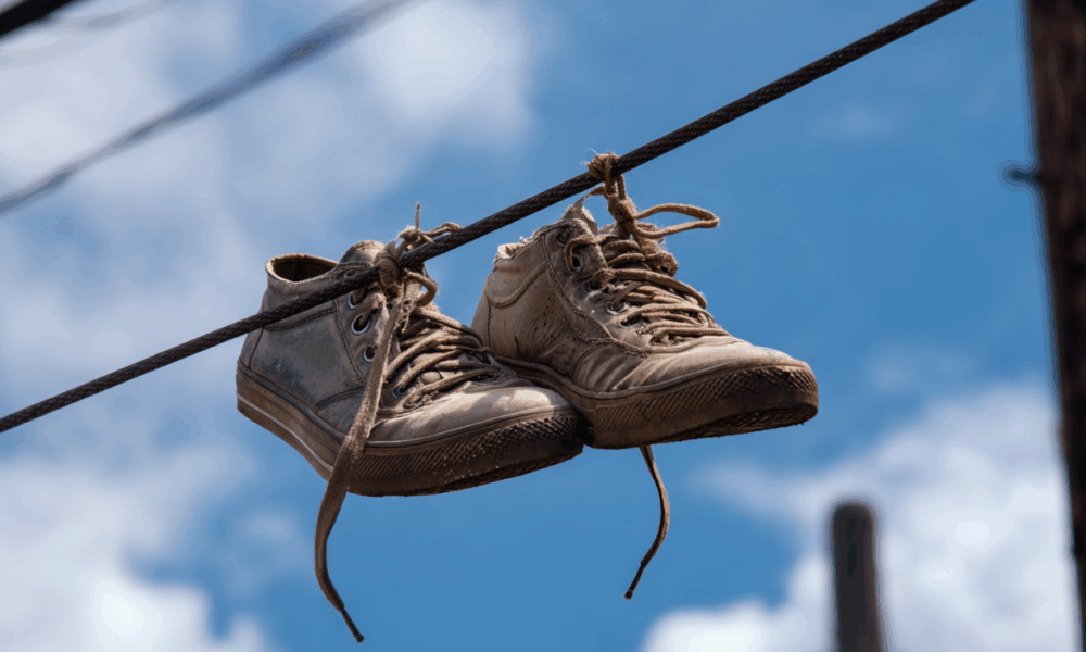 Many People Still Don’t Know The Meaning Behind Shoes Strung Up On A Power Line - featured image