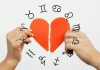 September Begins With a New Chapter for Every Zodiac Sign Two hands tearing a red paper heart in half with zodiac symbols around it on a light background