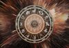 The One Guilty Pleasure Your Zodiac Sign Can’t Resist Glowing zodiac wheel with astrological symbols surrounded by warm brown and golden cosmic energy
